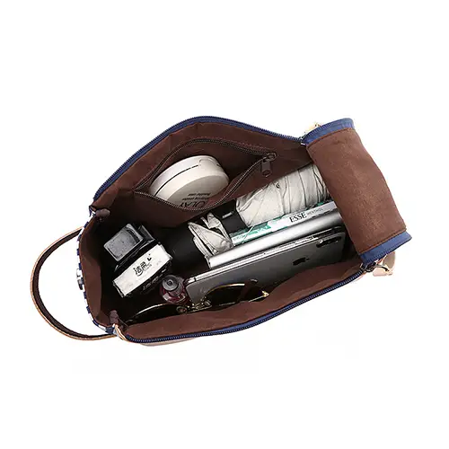 Heritage striped pattern on waxed canvas toiletry bag with reinforced leather handle detail